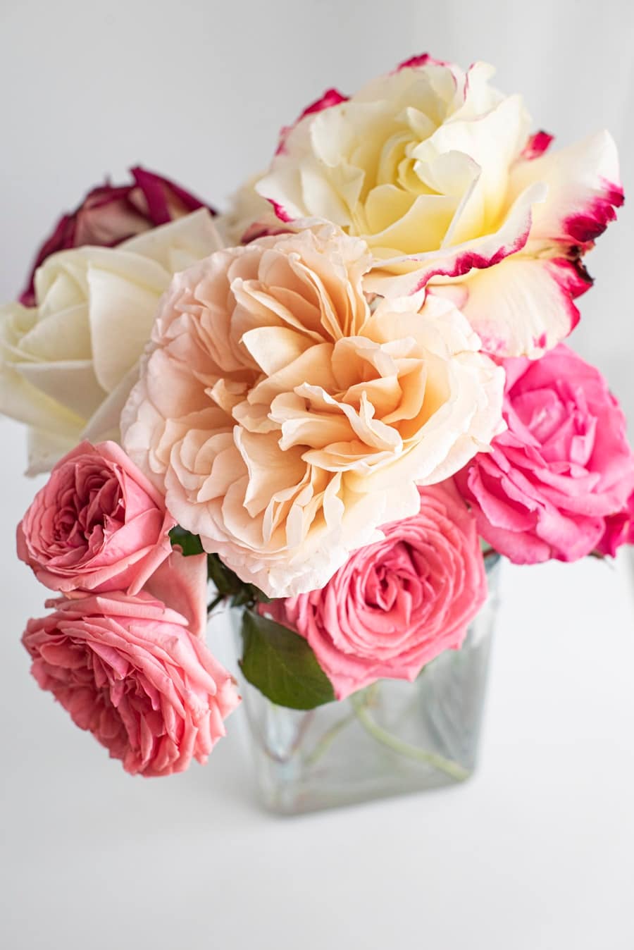 Bouquet de roses roses et crème dans un vase en verre